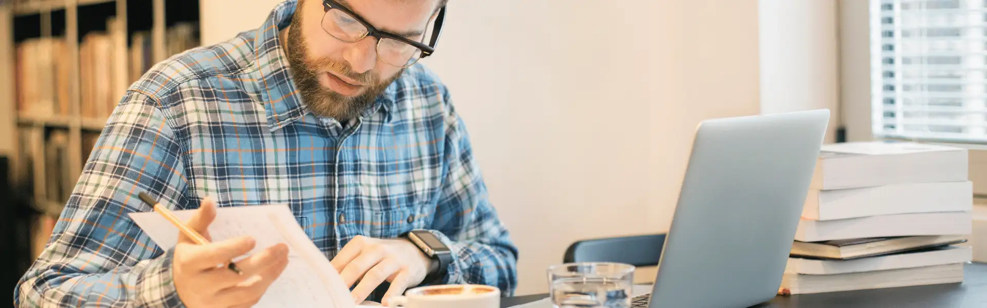 Italian researcher preparing an English-language journal manuscript at a desk